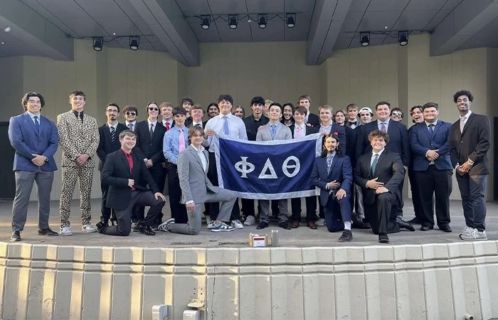 members of phi delta theta pose for a formal photo