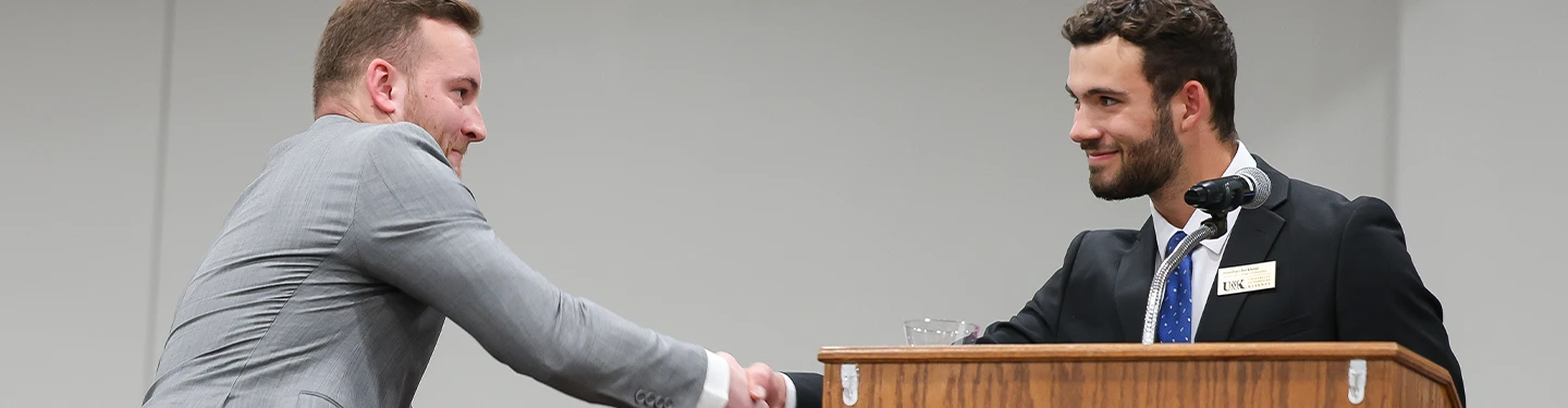 students shake hands at the inauguration