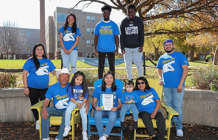 the unk family of the year pose for a photo outside the student union