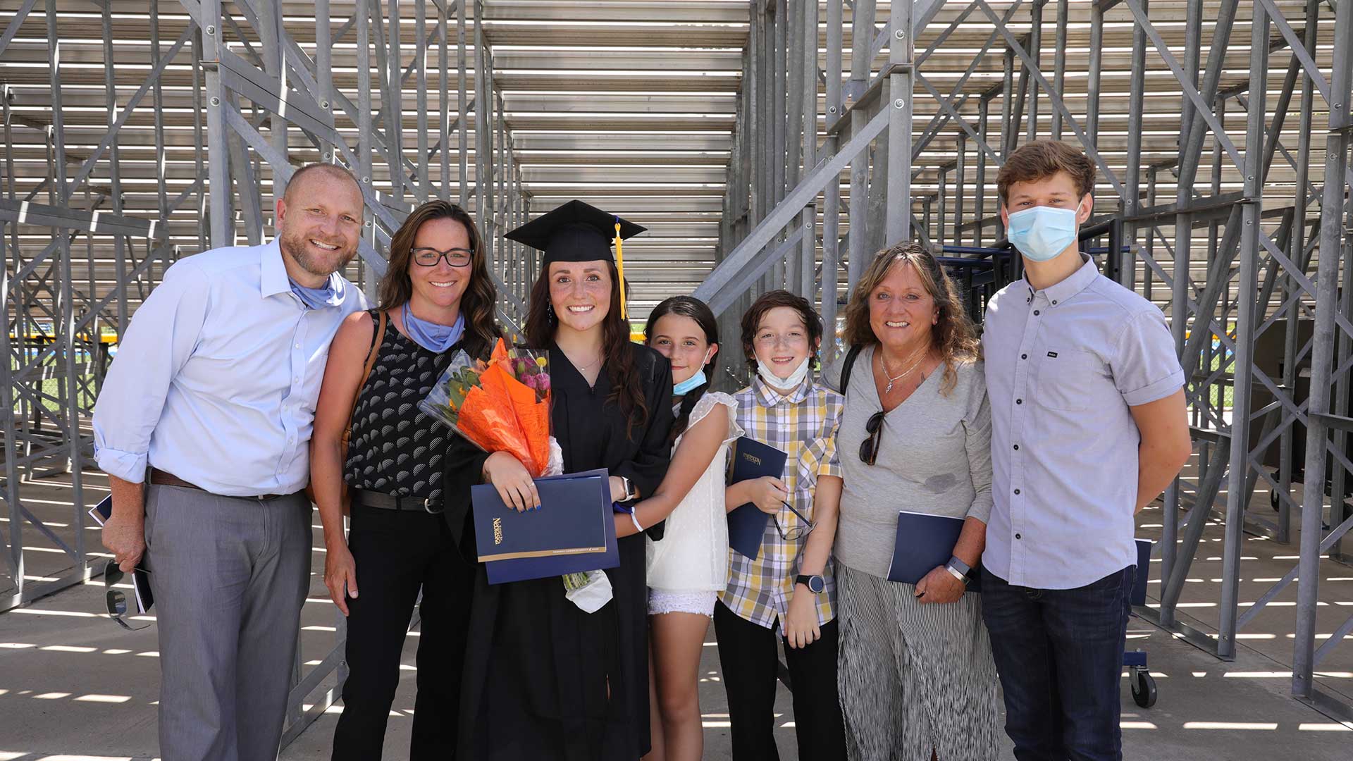 a student and their parents at graduation